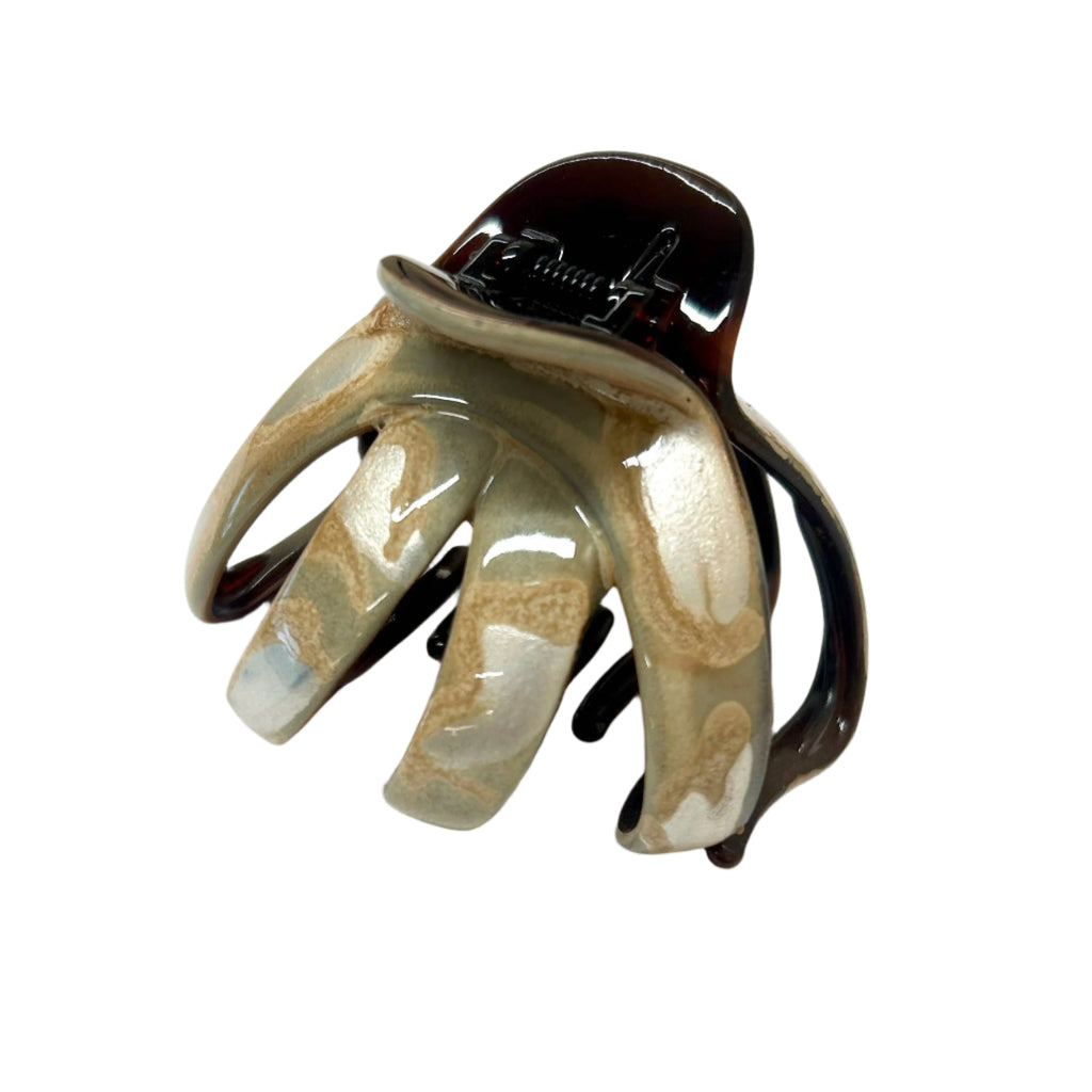 Claw hair clip with a decorative design on a white background