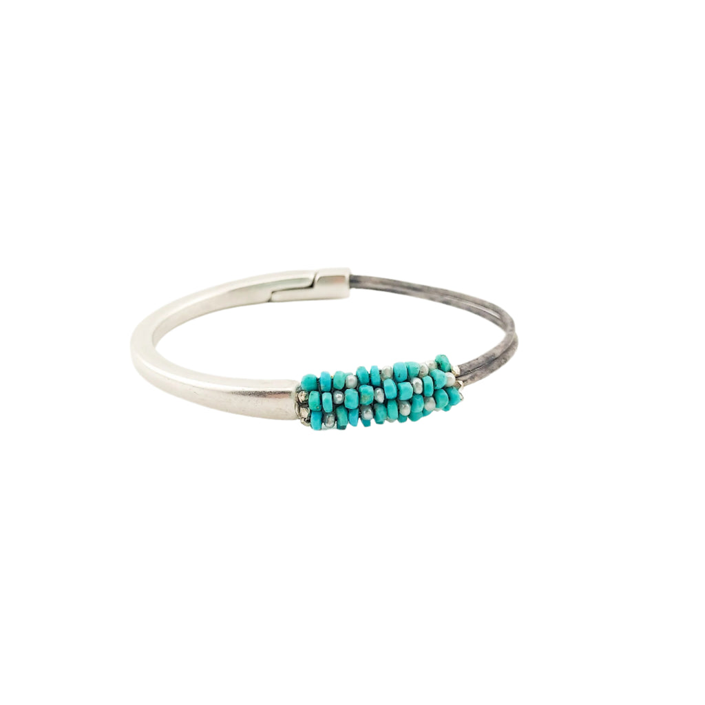 Silver bracelet with turquoise beads on a white background