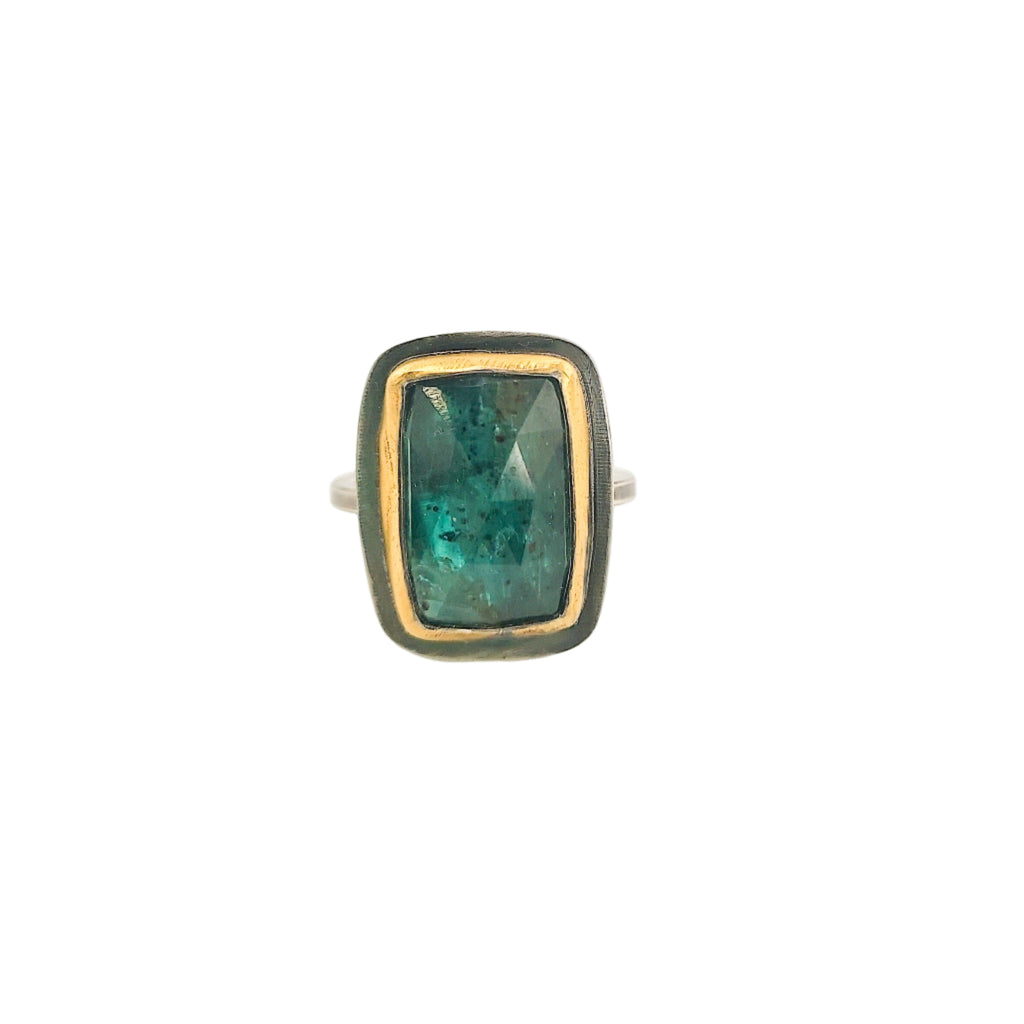 Ring with a green gemstone on a white background