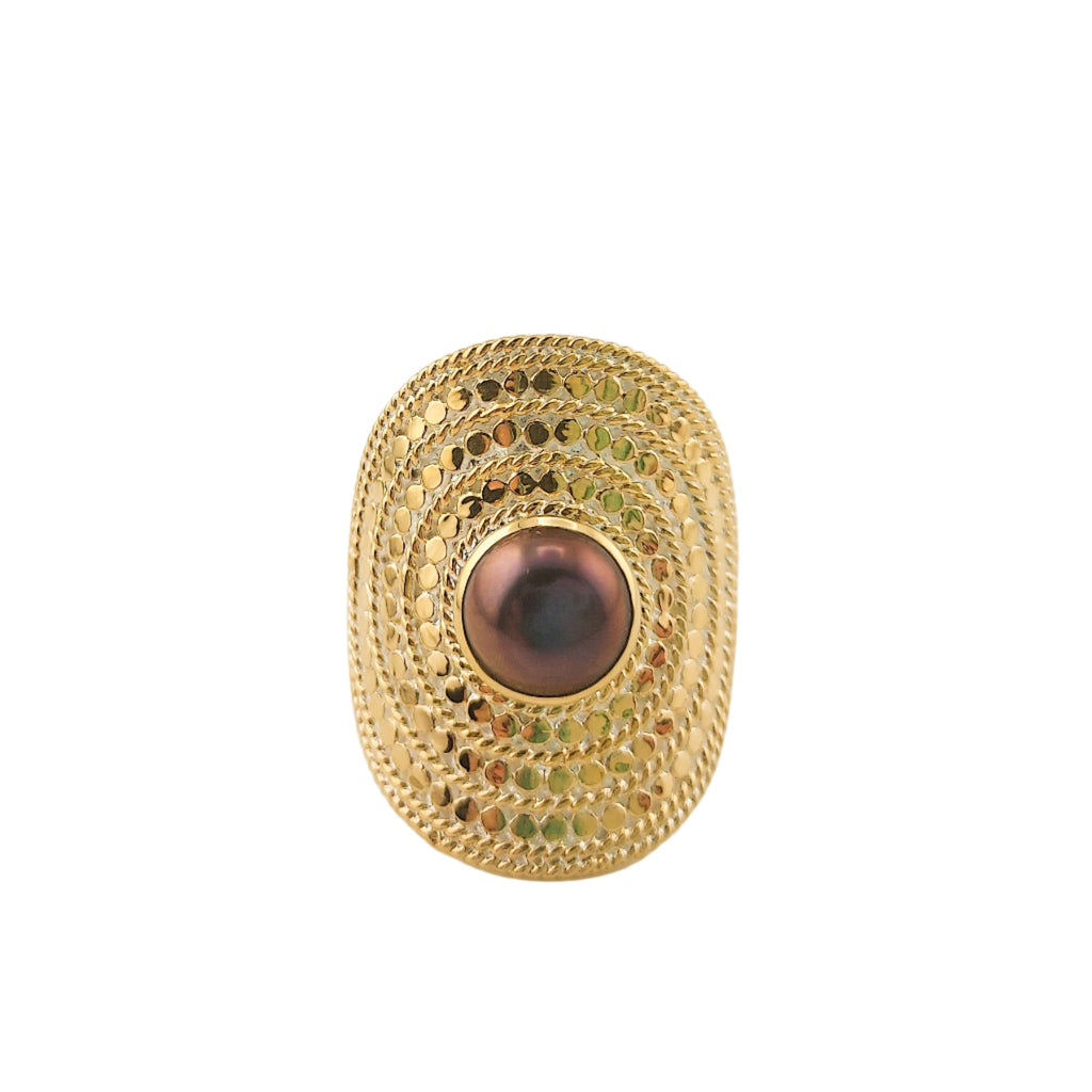 Gold ring with a central pearl on a white background