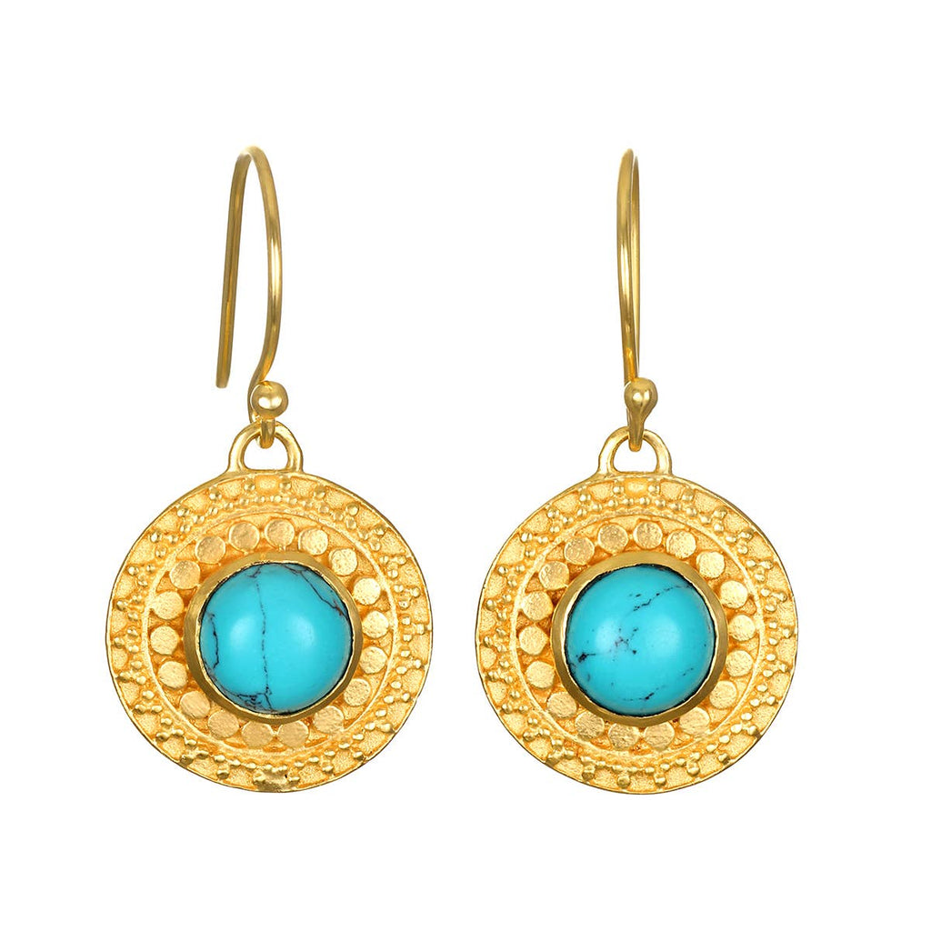 Gold earrings with turquoise stones on a white background