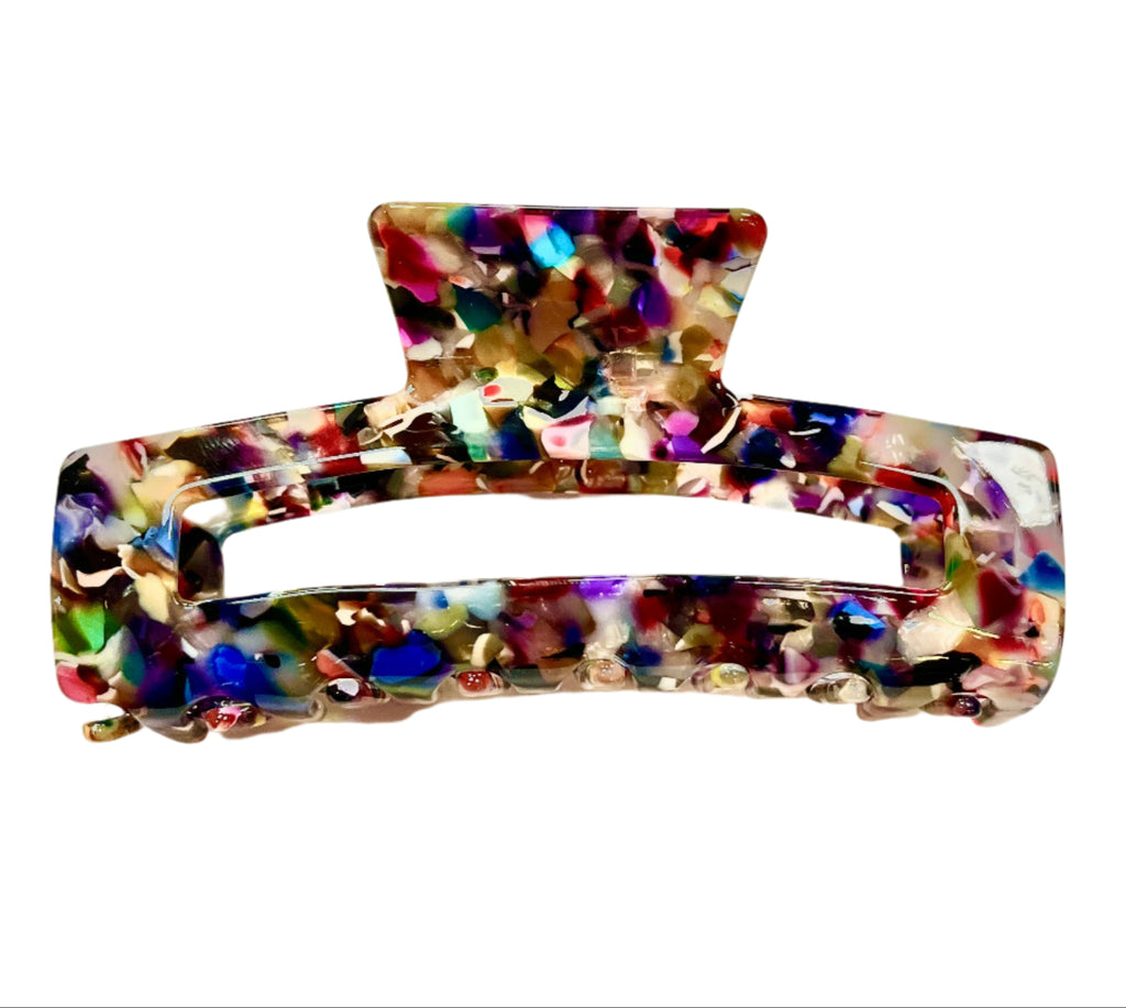 Multicolored rectangular hair clip on a light background
