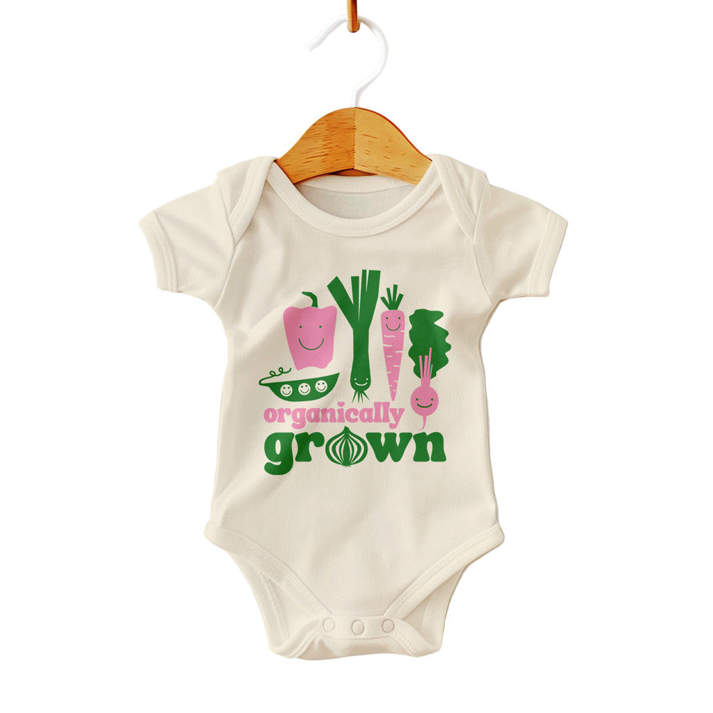 Baby onesie with vegetable graphics and 'organically grown' text on a white background