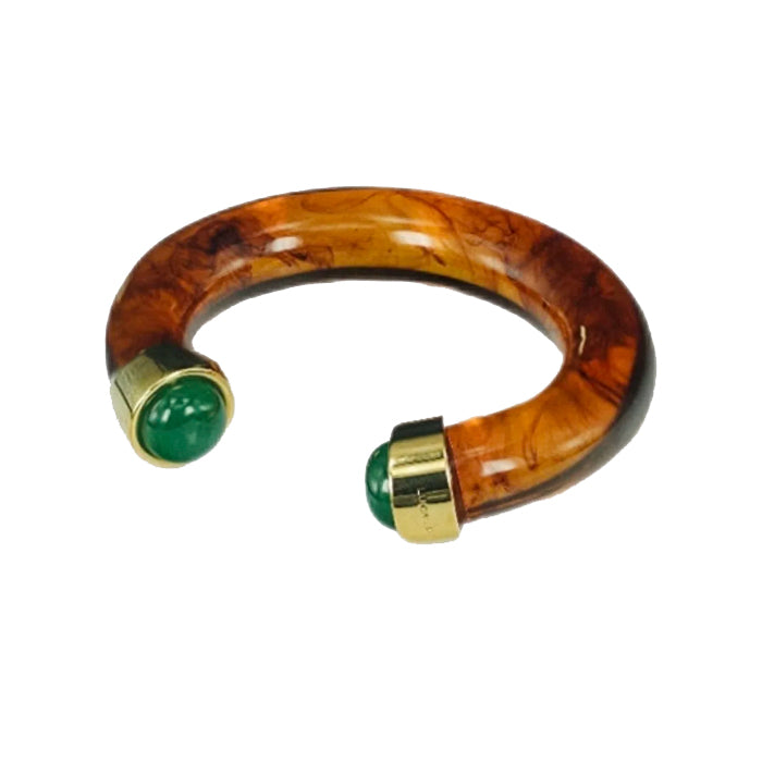 Resin bracelet with green stones and gold accents on a white background