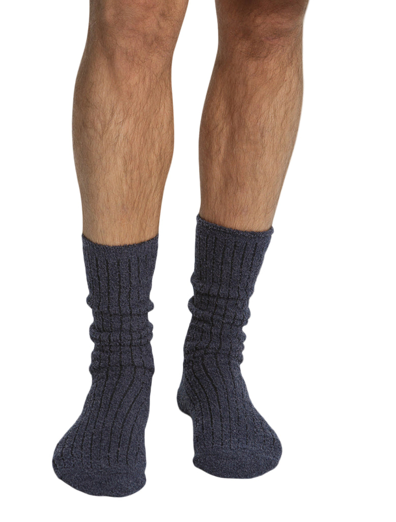 Navy blue socks worn by a person on a white background