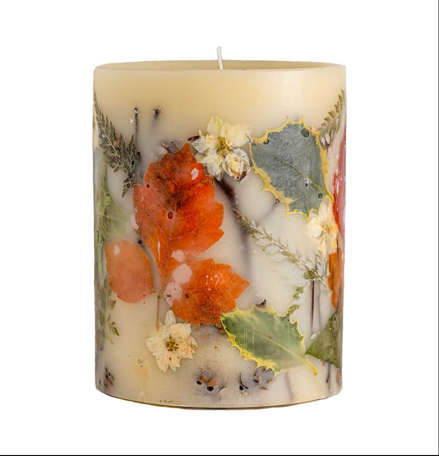 Candle with floral and leaf decorations on a white background