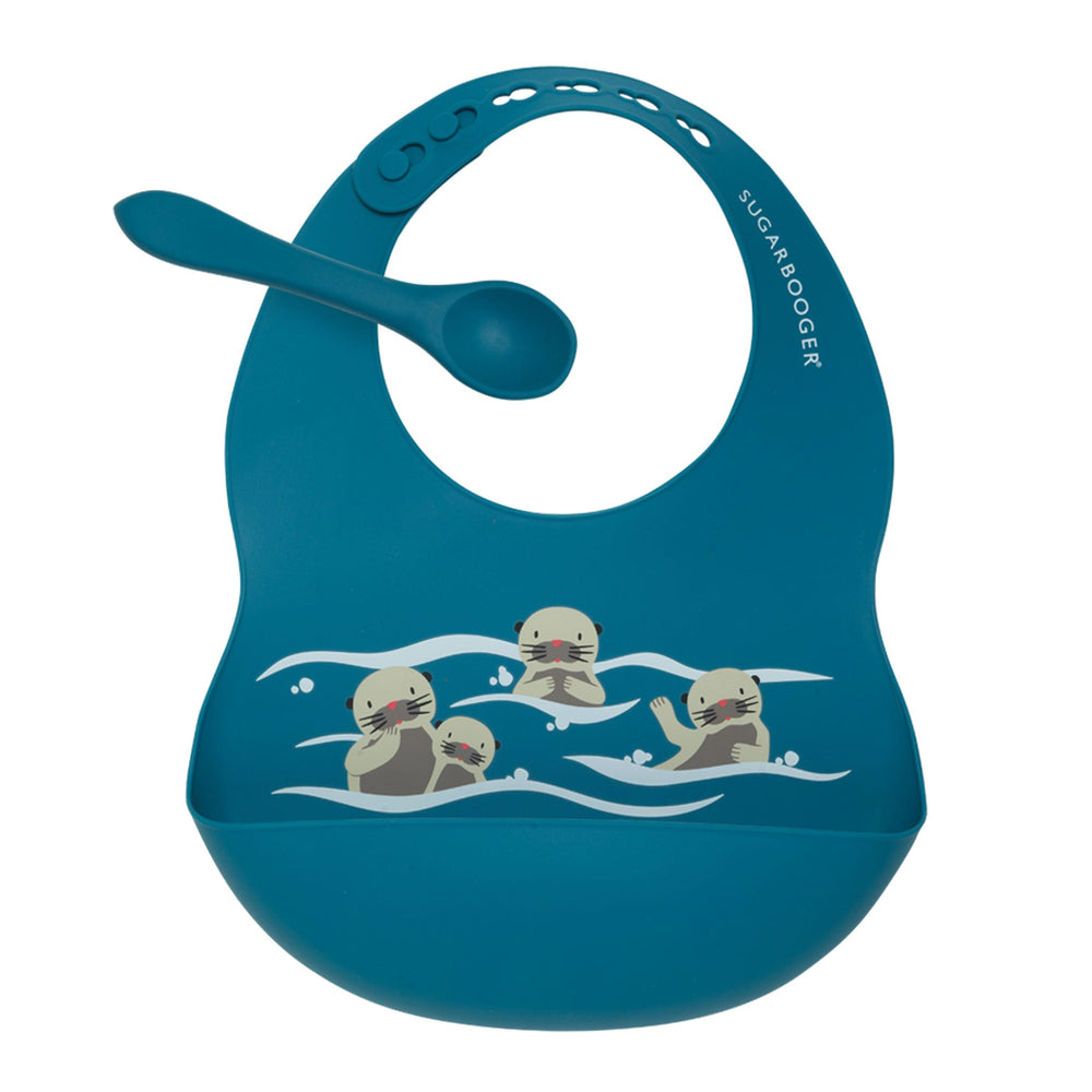 Blue bib with cartoon otters and matching spoon on a white background