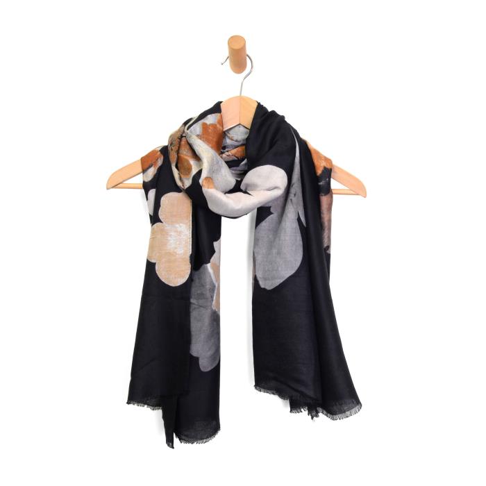 black floral scarf on hanger on white background