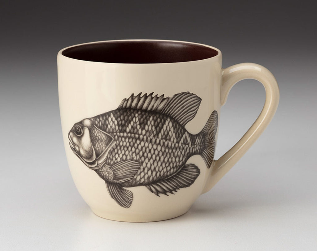 Beige mug with fish design on a gray background