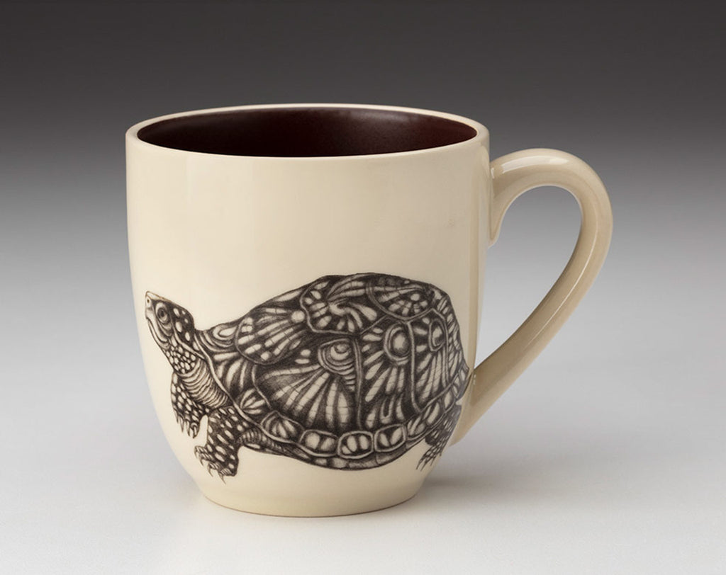 Ceramic mug with a tortoise design on a white background