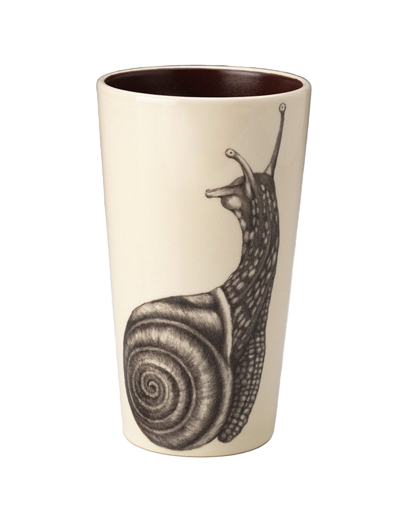 Ceramic tumbler with a snail design on a plain background