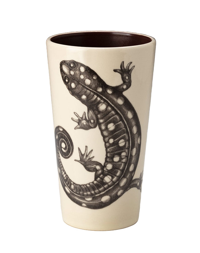 Ceramic tumbler with a black lizard design on a white background