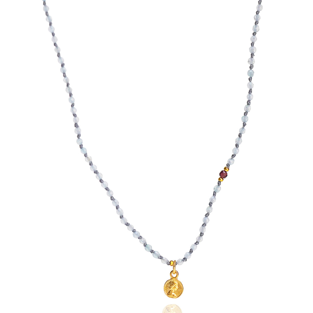 Necklace with a small gold pendant on a white background