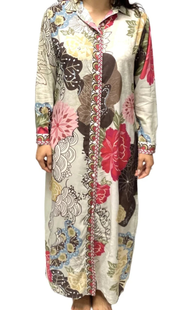 Woman wearing a long, patterned dress against a white background