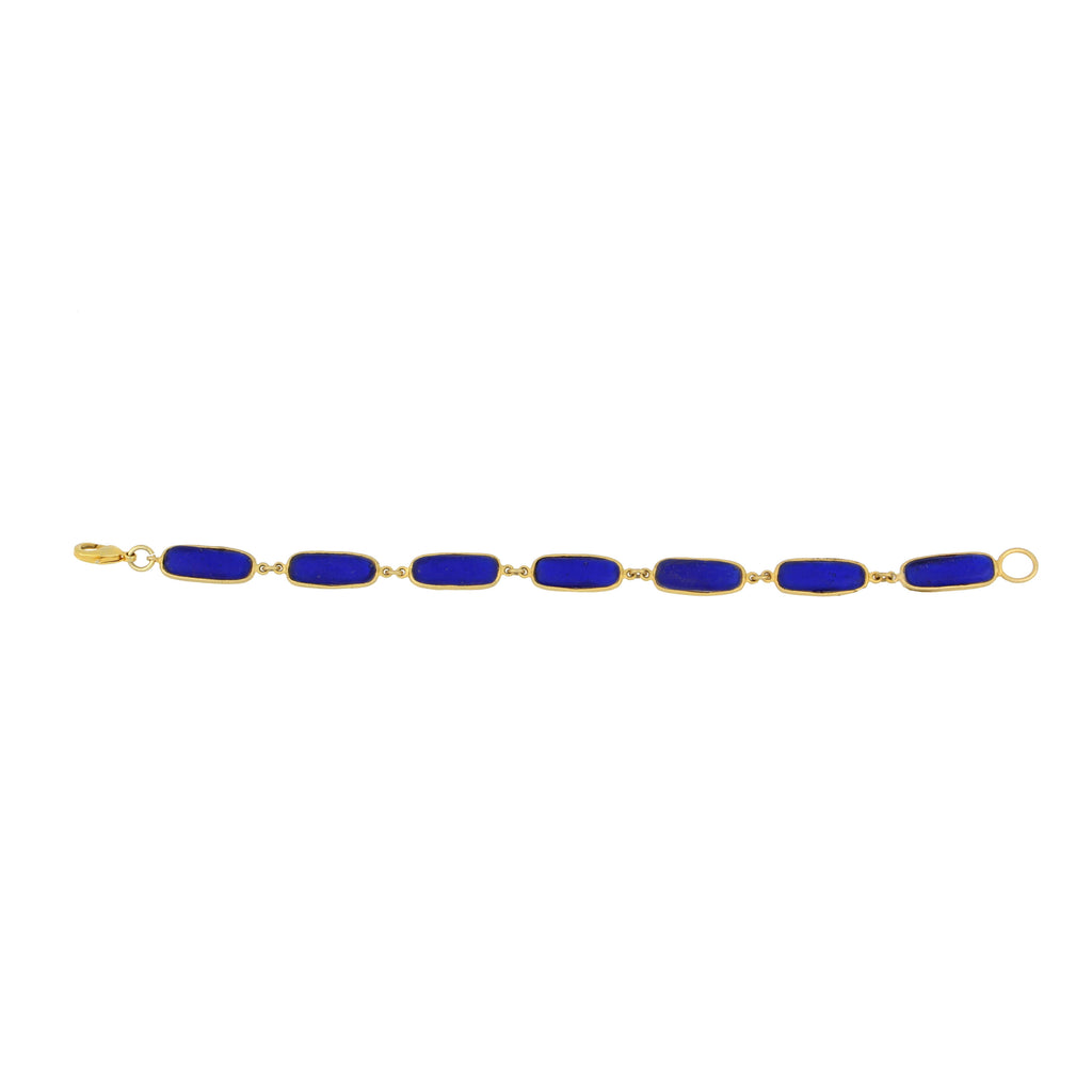 Gold bracelet with blue stones on a white background