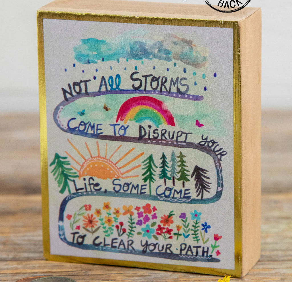 Decorative box with motivational quote and illustrations on a wooden surface