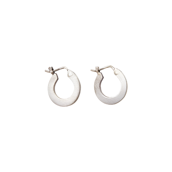 A pair of silver flat hoop earrings with hinged ear wires and snap down clasts.