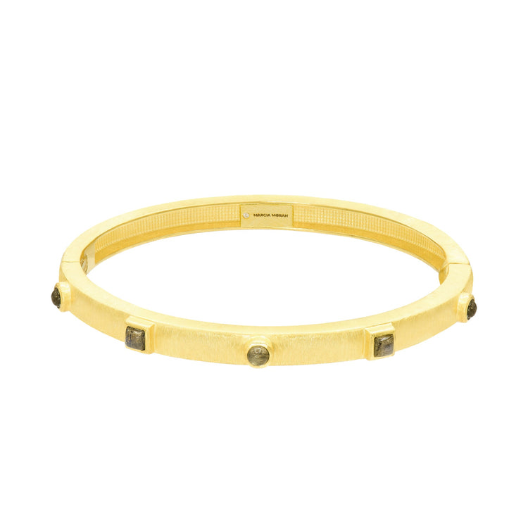 Gold bracelet with embedded Labradorite on a white background