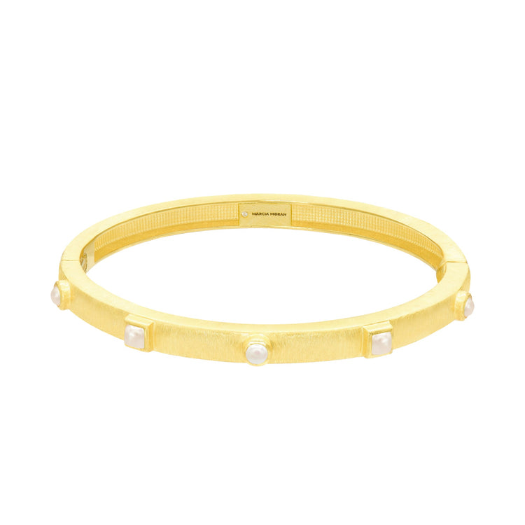 Gold bracelet with embedded stones on a white background