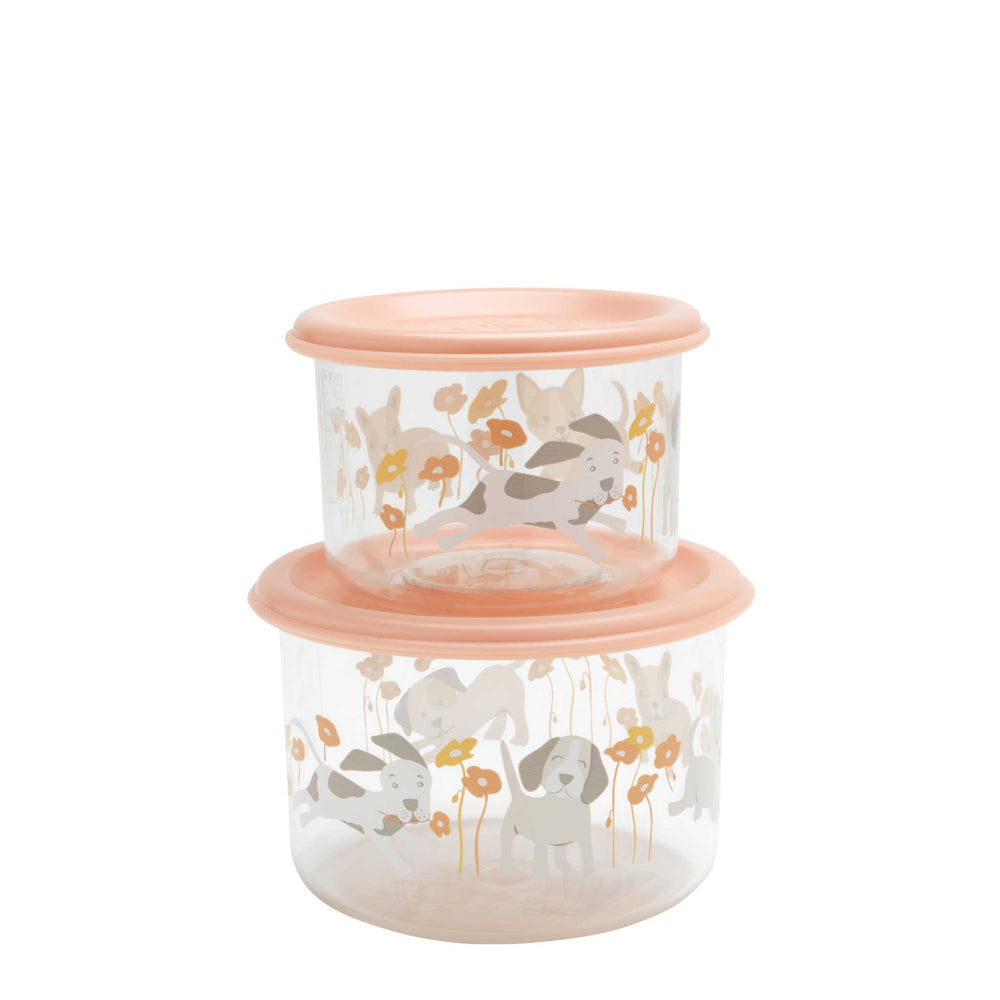 Two stacked glass containers with floral and animal design lids on a white background