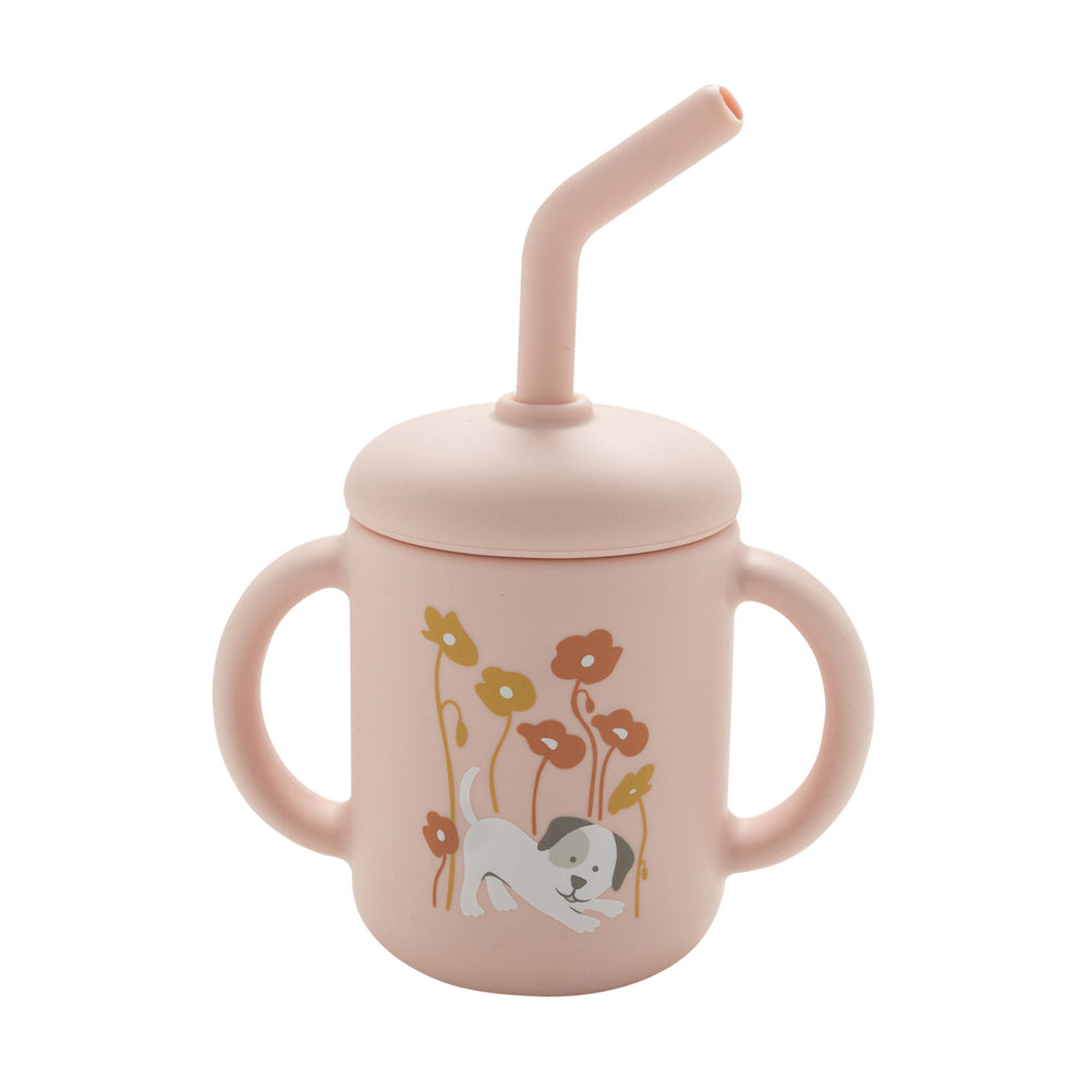 Pink children's cup with floral + puppy design and straw on a white background