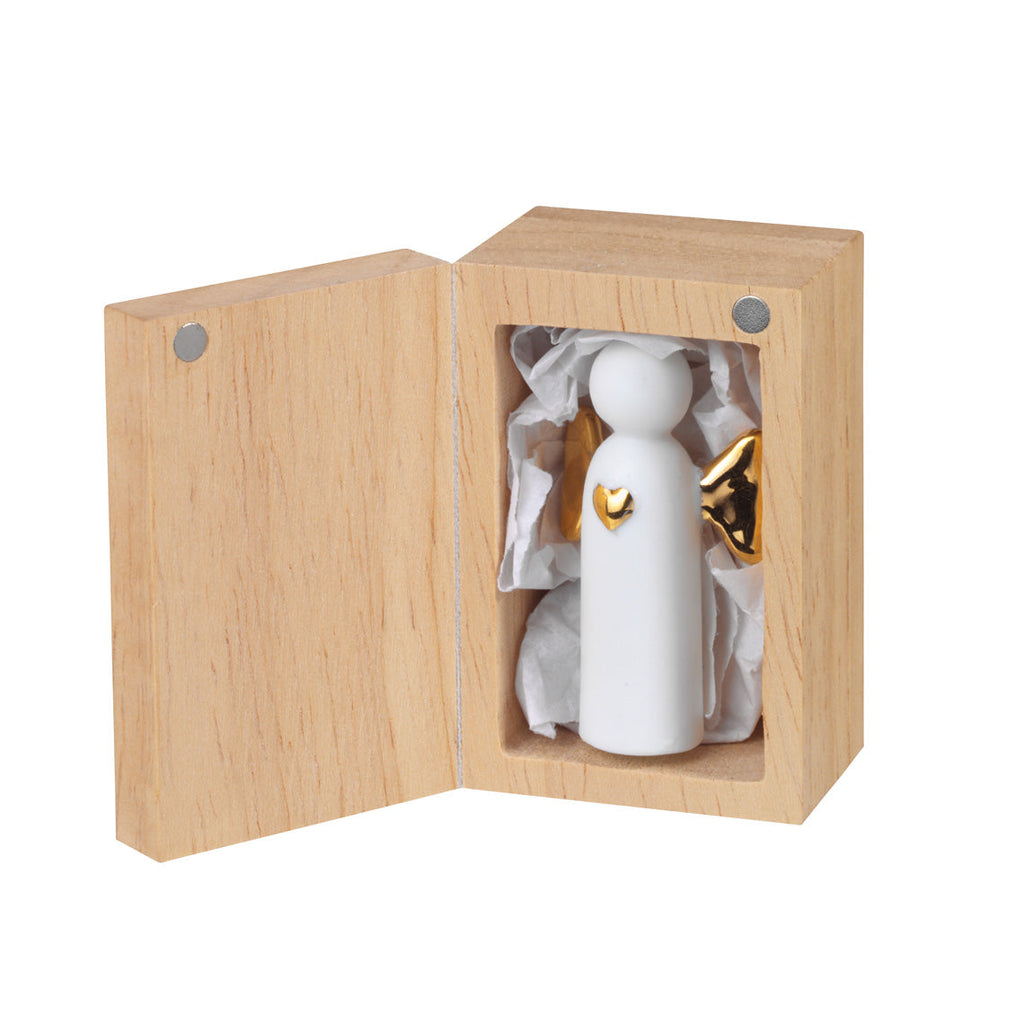 White ceramic figurine with gold heart detail in a wooden box on a white background