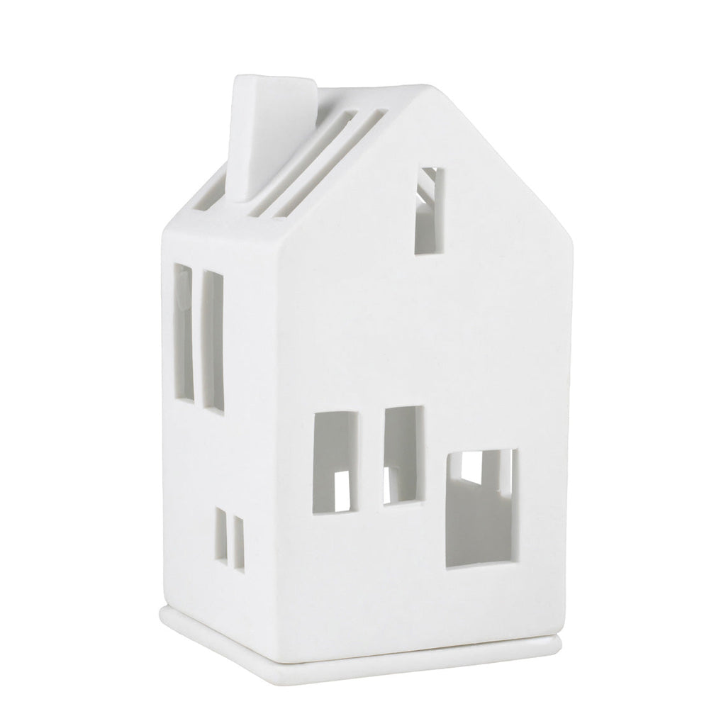 White house-shaped candle holder on a white background