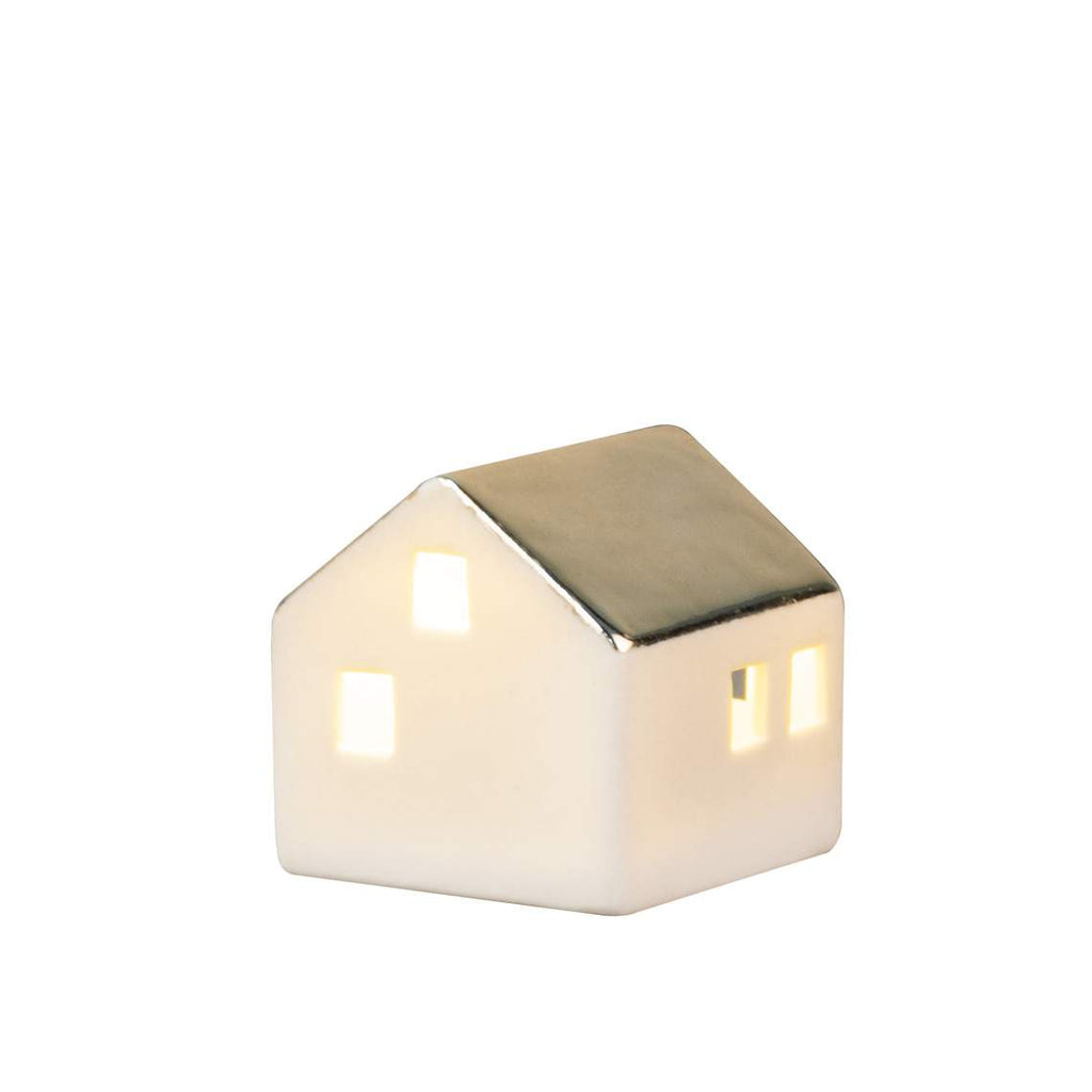 Small house-shaped candle on a white background