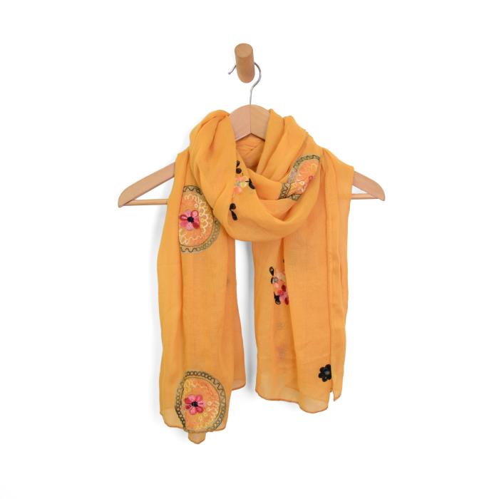 Yellow scarf with floral embroidery on a wooden hanger against a white background