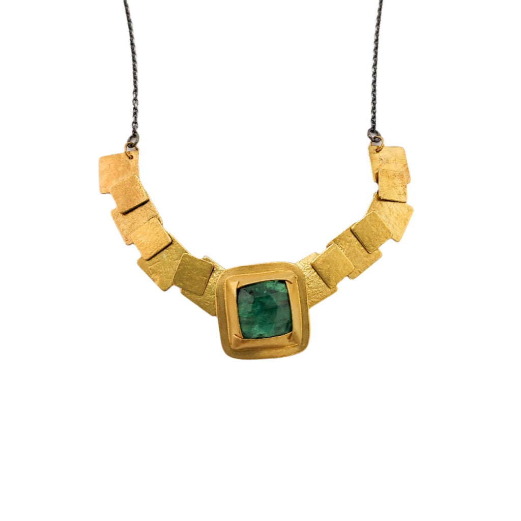 square pivot necklace in gold with green kyanite on an oxidized silver chain over a white background