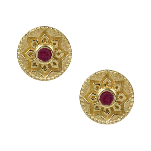 Pair of gold earrings with red gemstones on a white background