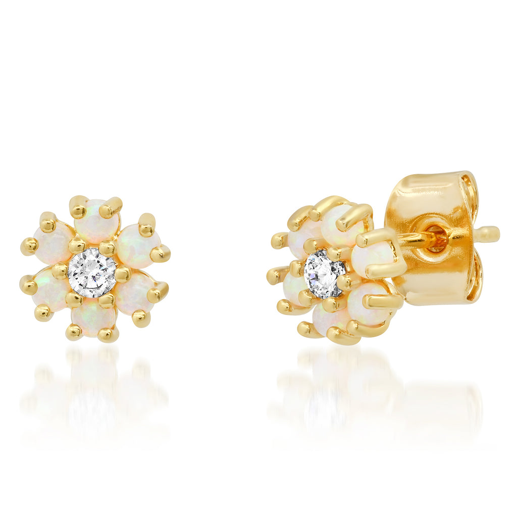 Gold earrings with white stones on a white background