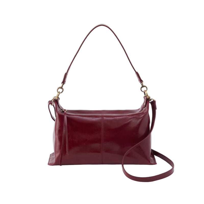 Maroon handbag with a strap on a white background