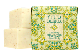 white tea calendula bar soap with wrapped bar in front in green and yellow wrapper