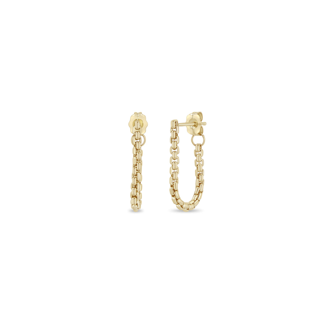 Gold chain hoop earrings on a white background