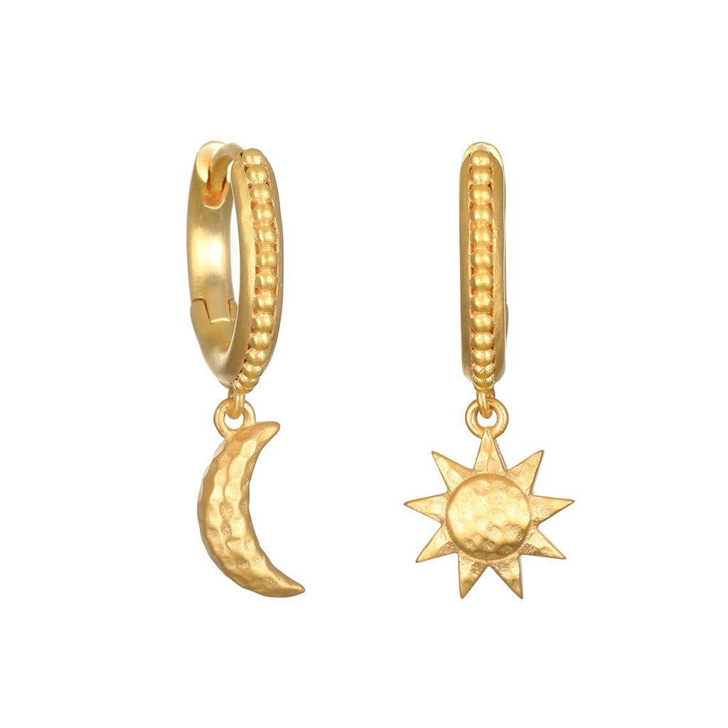Gold hoop earrings with moon and sun charms on a white background