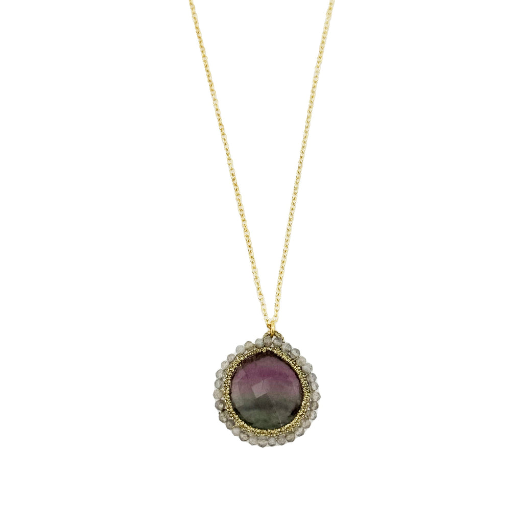 Necklace with a pendant featuring a purple stone on a white background