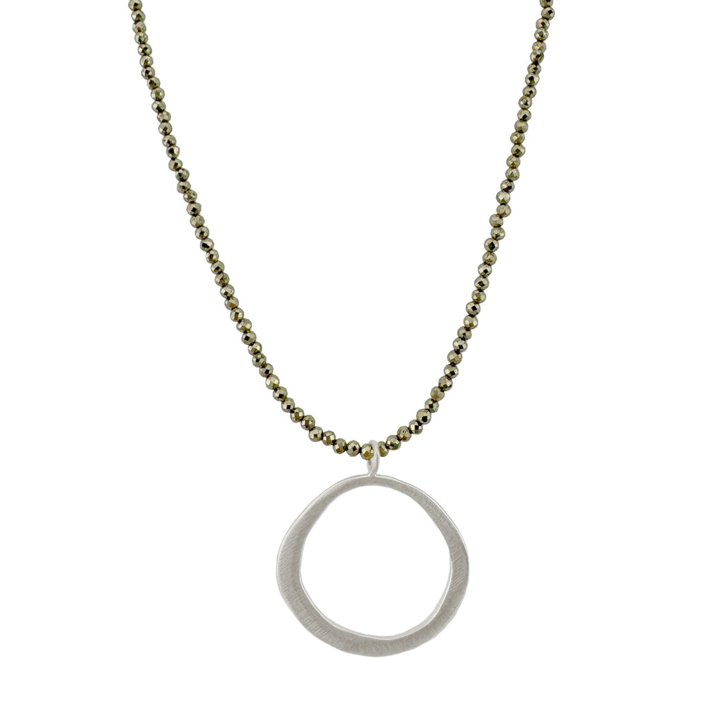 Necklace with a silver circle pendant on beads on a white background