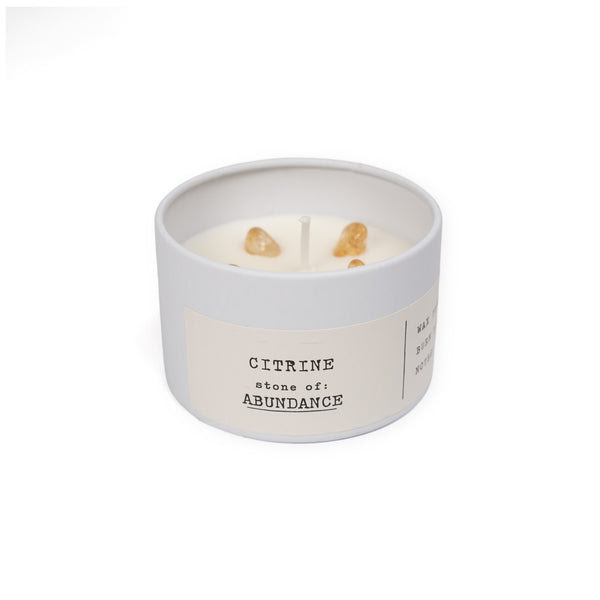 white candle tin with citrine on white background