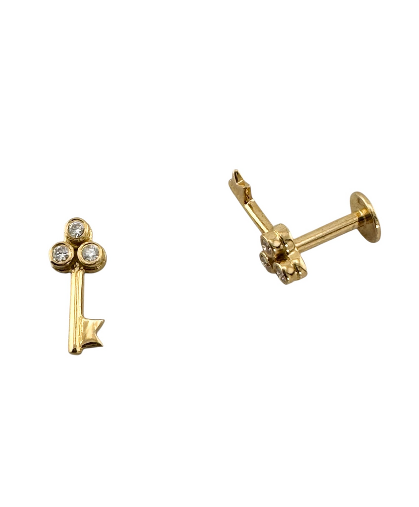 gold key shaped earrings with 3 diamonds at top showing flat back