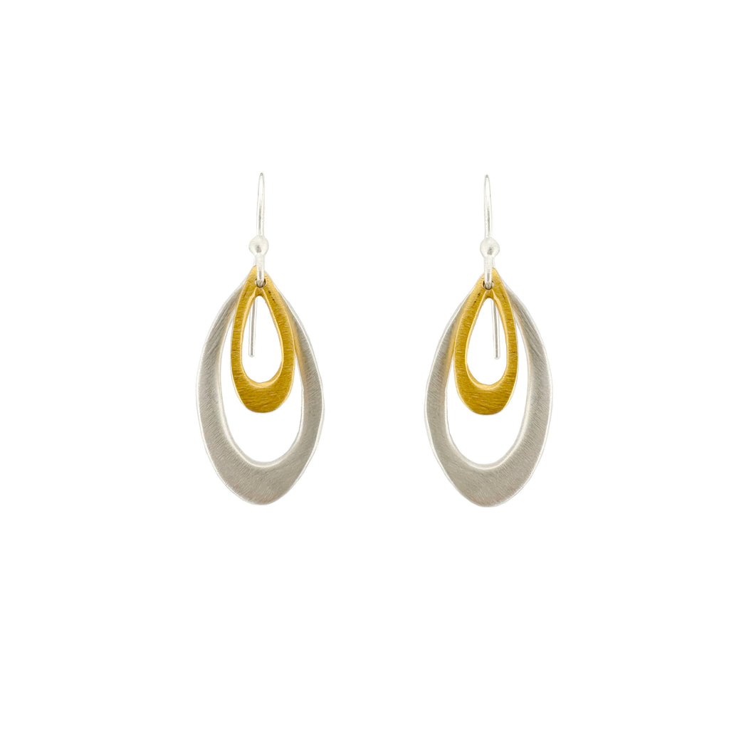 Pair of silver and gold earrings on a white background