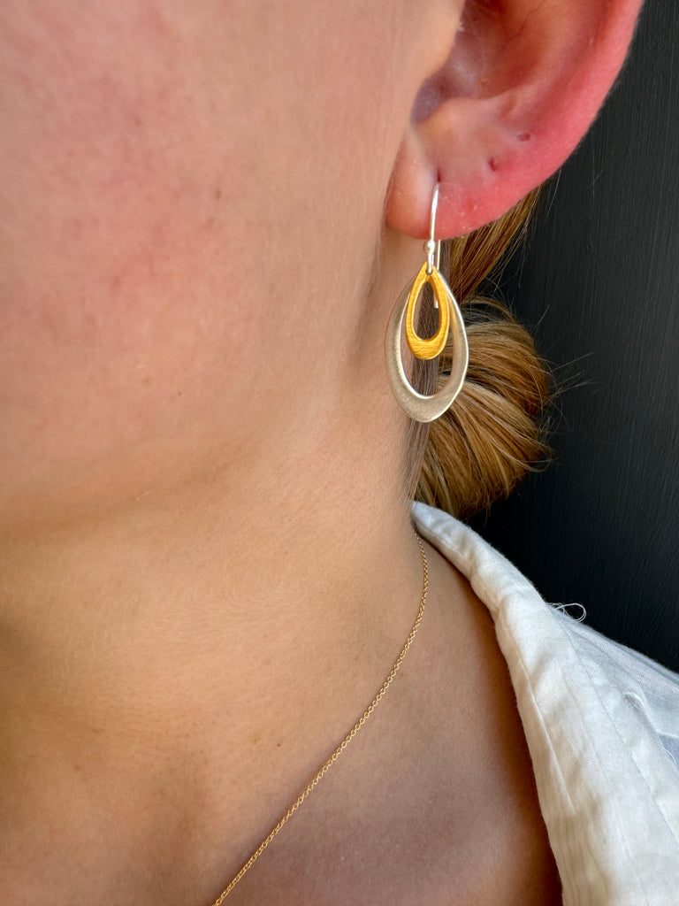 double leaf earrings on persons ear