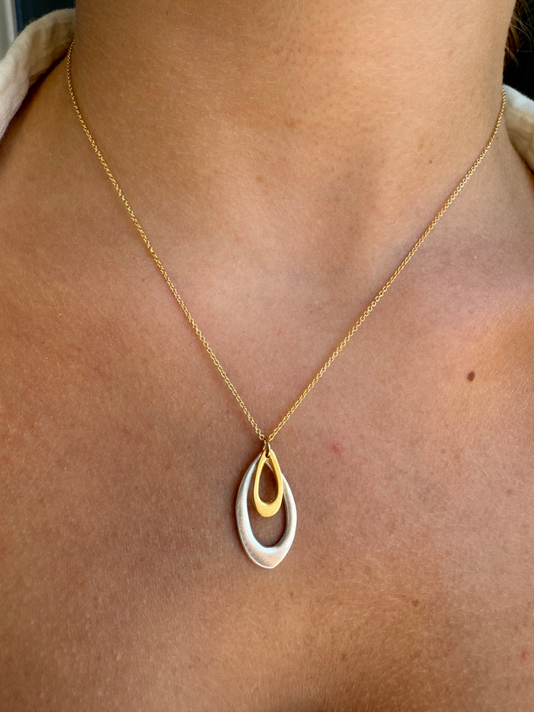 double leaf necklace on persons neck