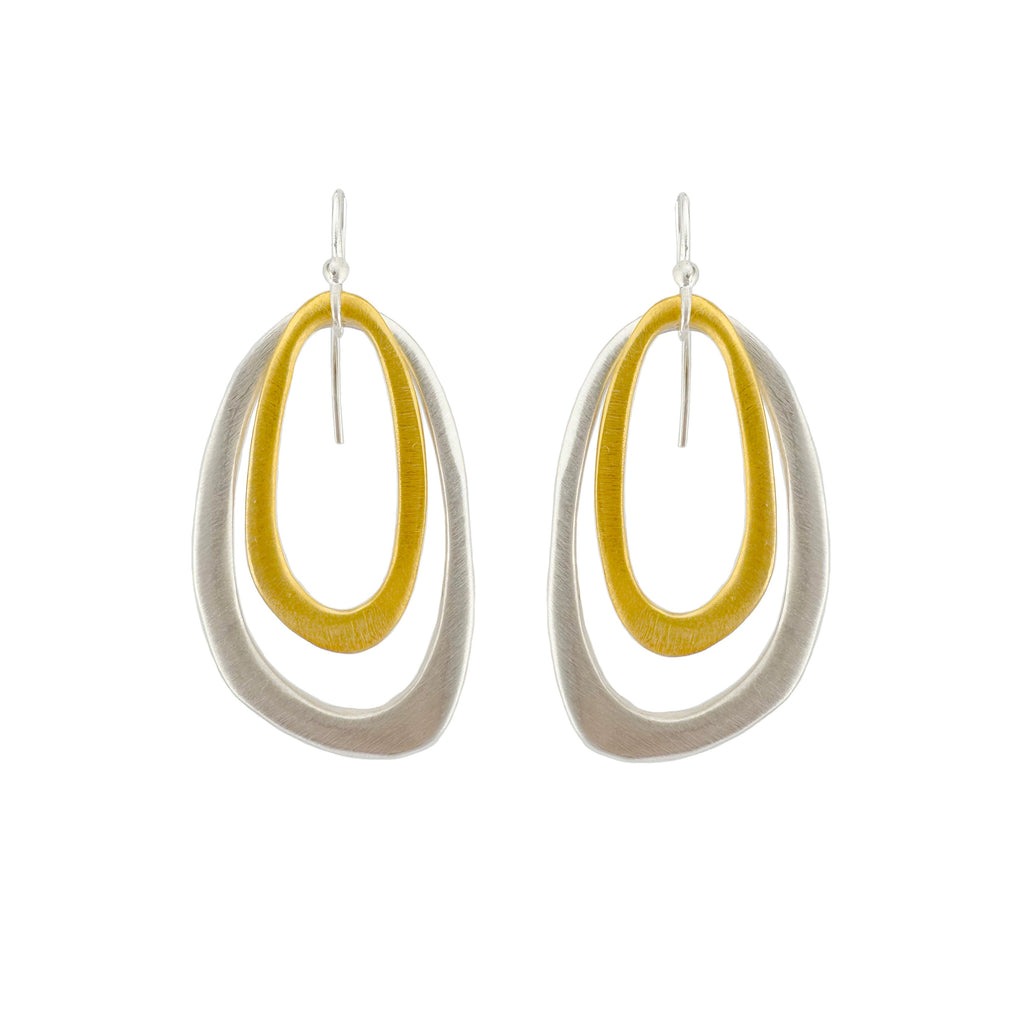 Pair of earrings with yellow and silver oval designs on a white background