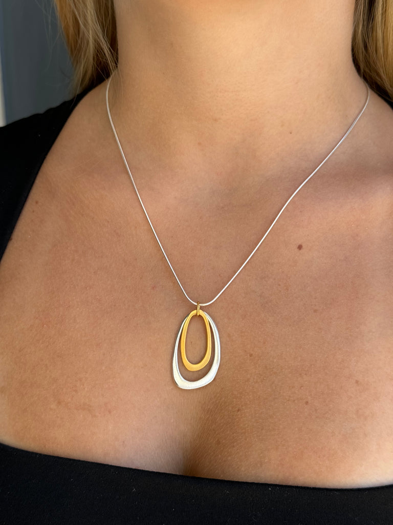 Necklace with a unique pendant worn by a person