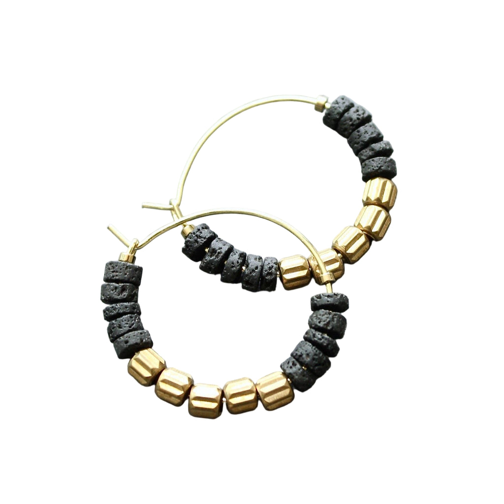 Pair of hoop earrings with black and gold beads on a light blue background