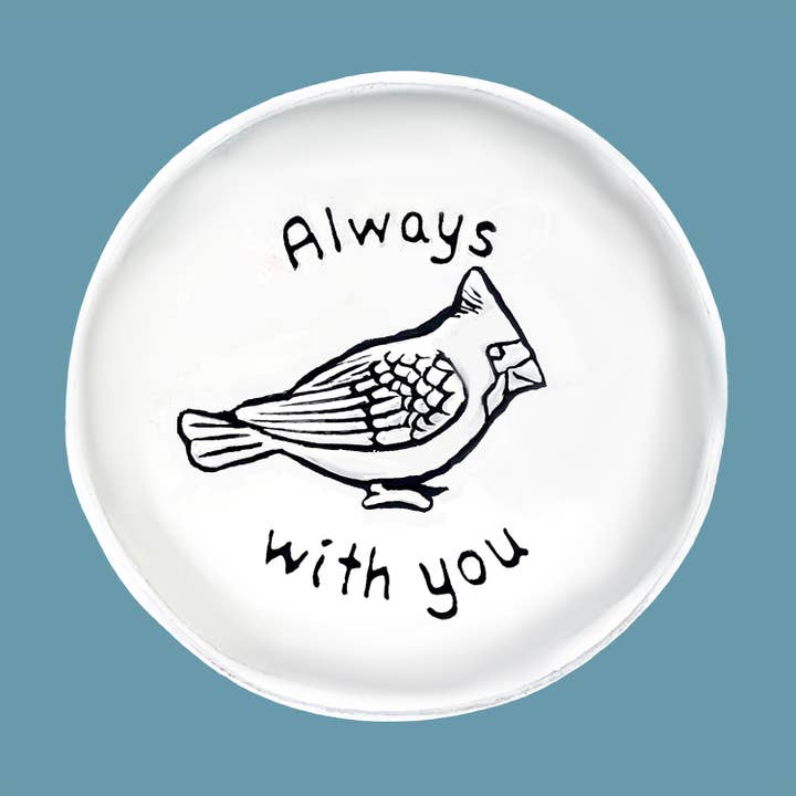 White plate with a bird illustration and 'Always with you' text on a blue background