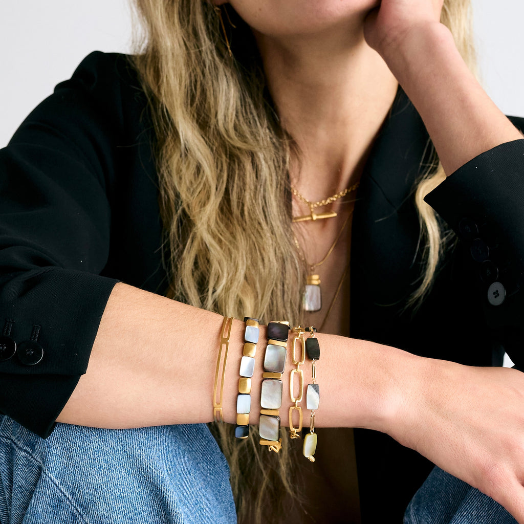 grey mother of pearl rectangles w. links bracelet in vermeil on wrist with four other bracelets