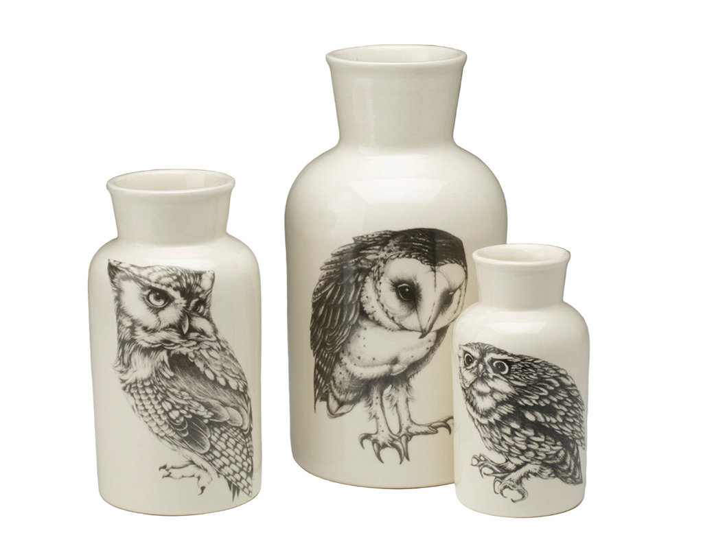 Three ceramic vases with owl illustrations on a white background