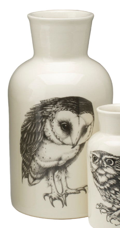 Three ceramic vases with owl illustrations on a white background